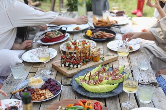 group of people dining at table outdoors