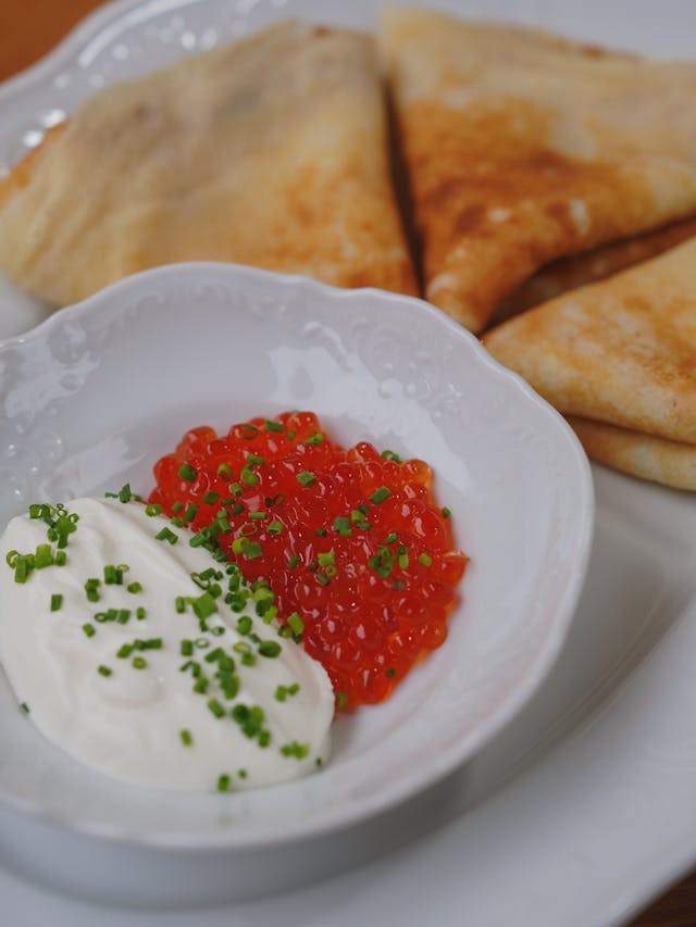 pancakes with dish of red roe and chives