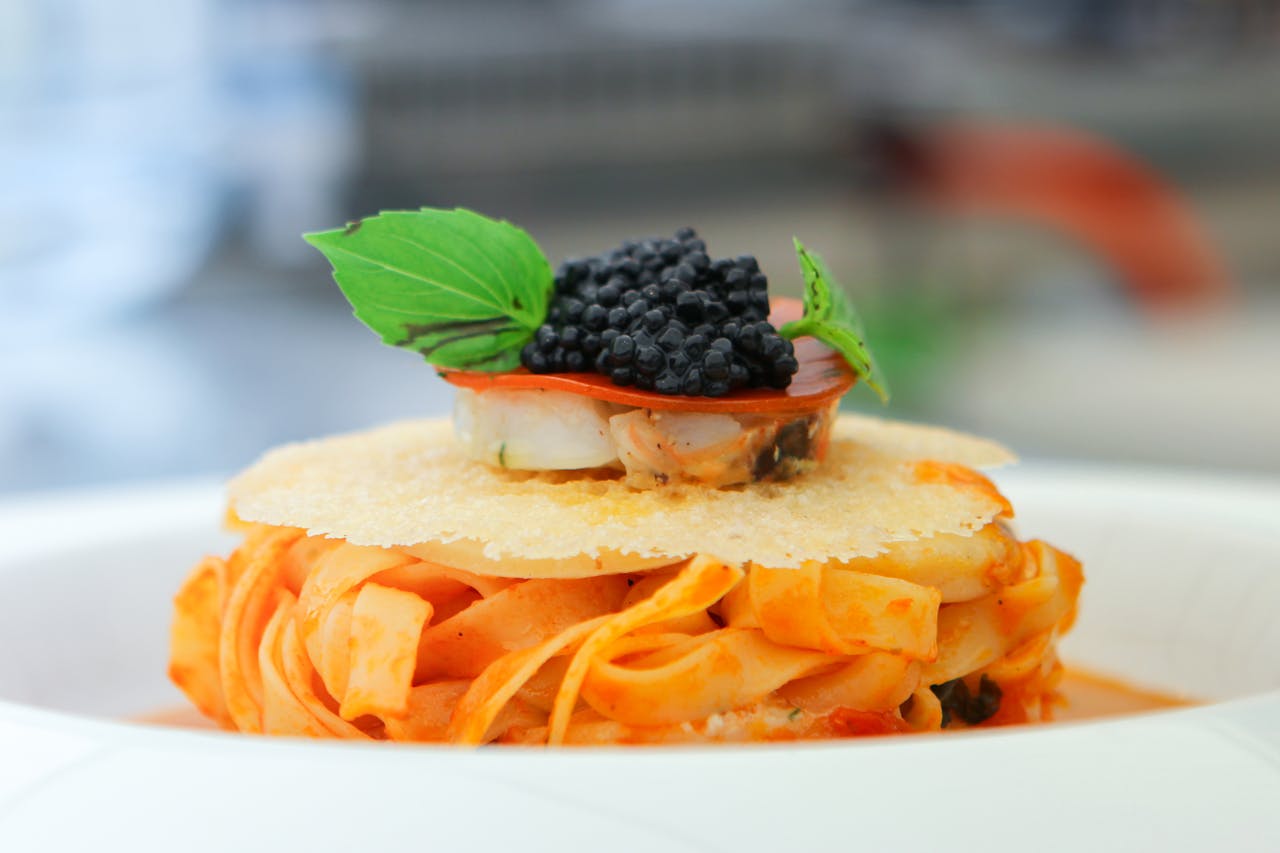 pasta topped with black caviar garnish