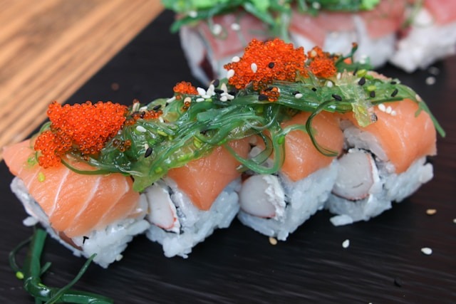 plate of sushi with red roe garnish