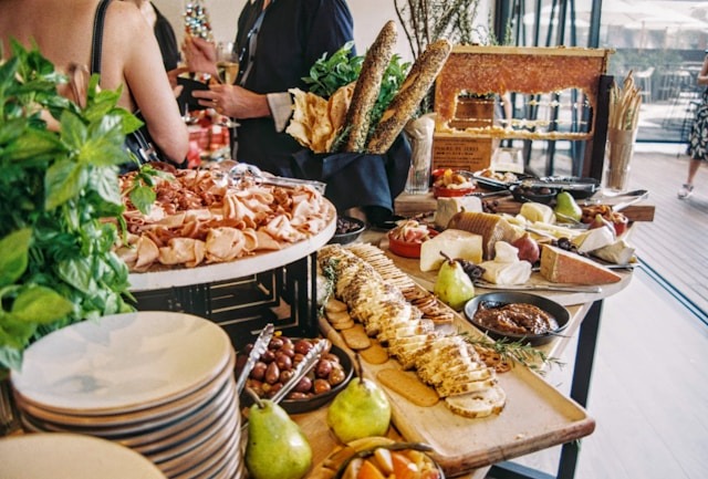 stack of plates and appetizers displayed on table at party