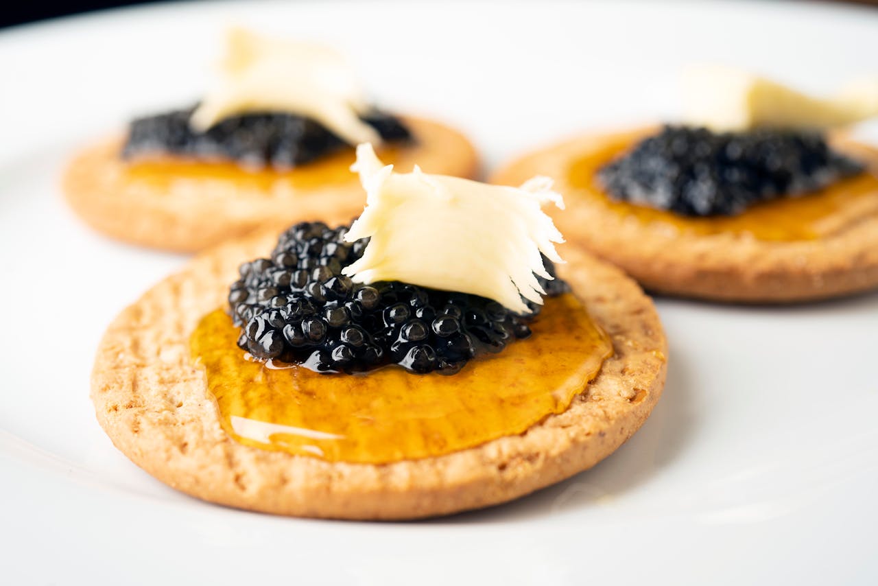 black caviar and honey on crackers