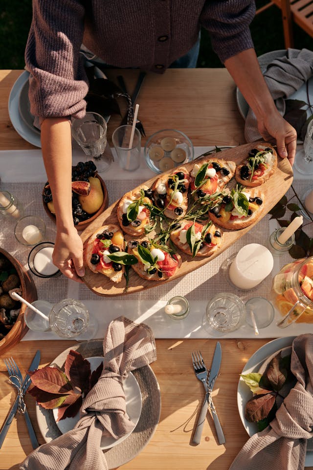 person holding plate of appetizers at dinner party