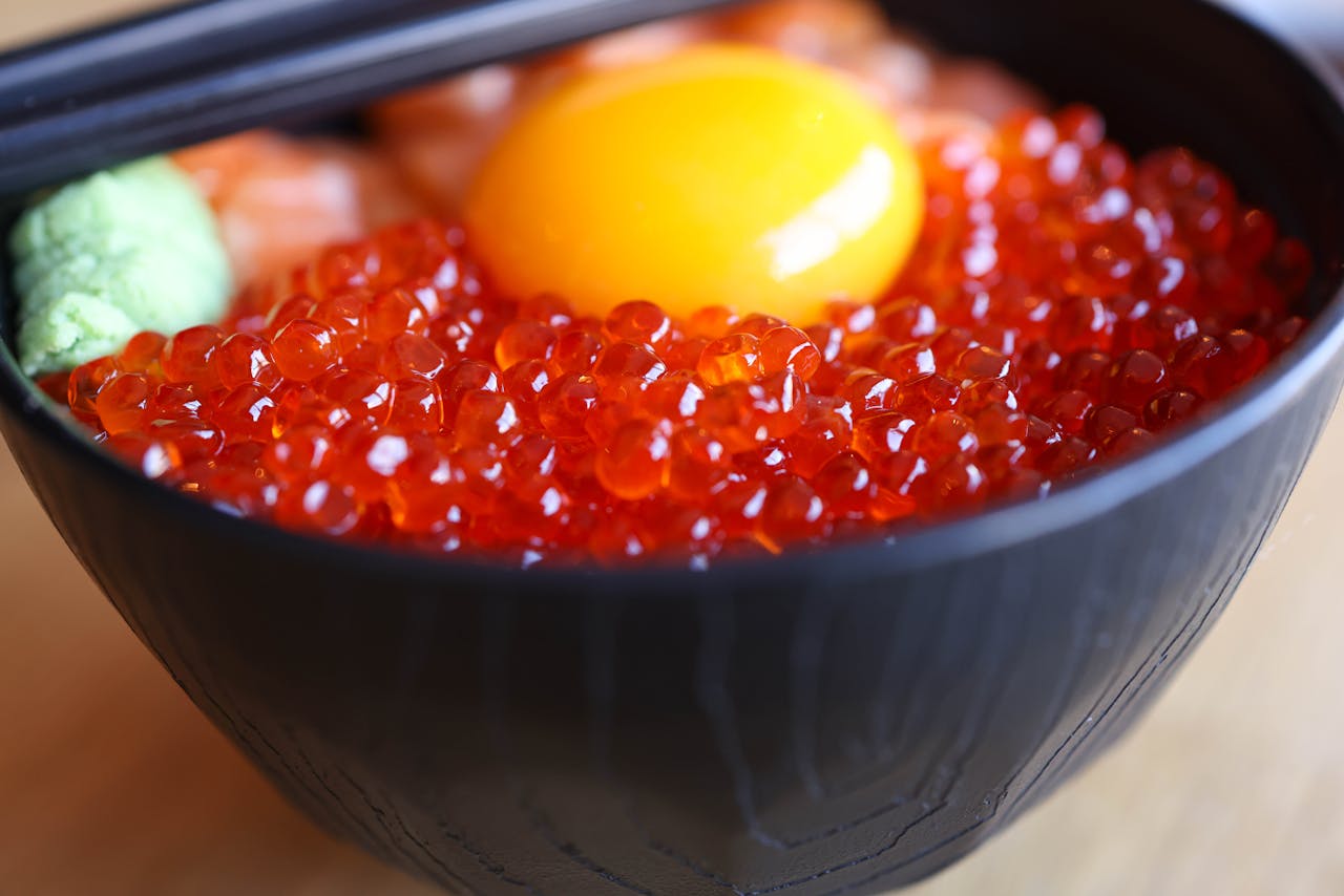 bowl of red caviar with egg on top