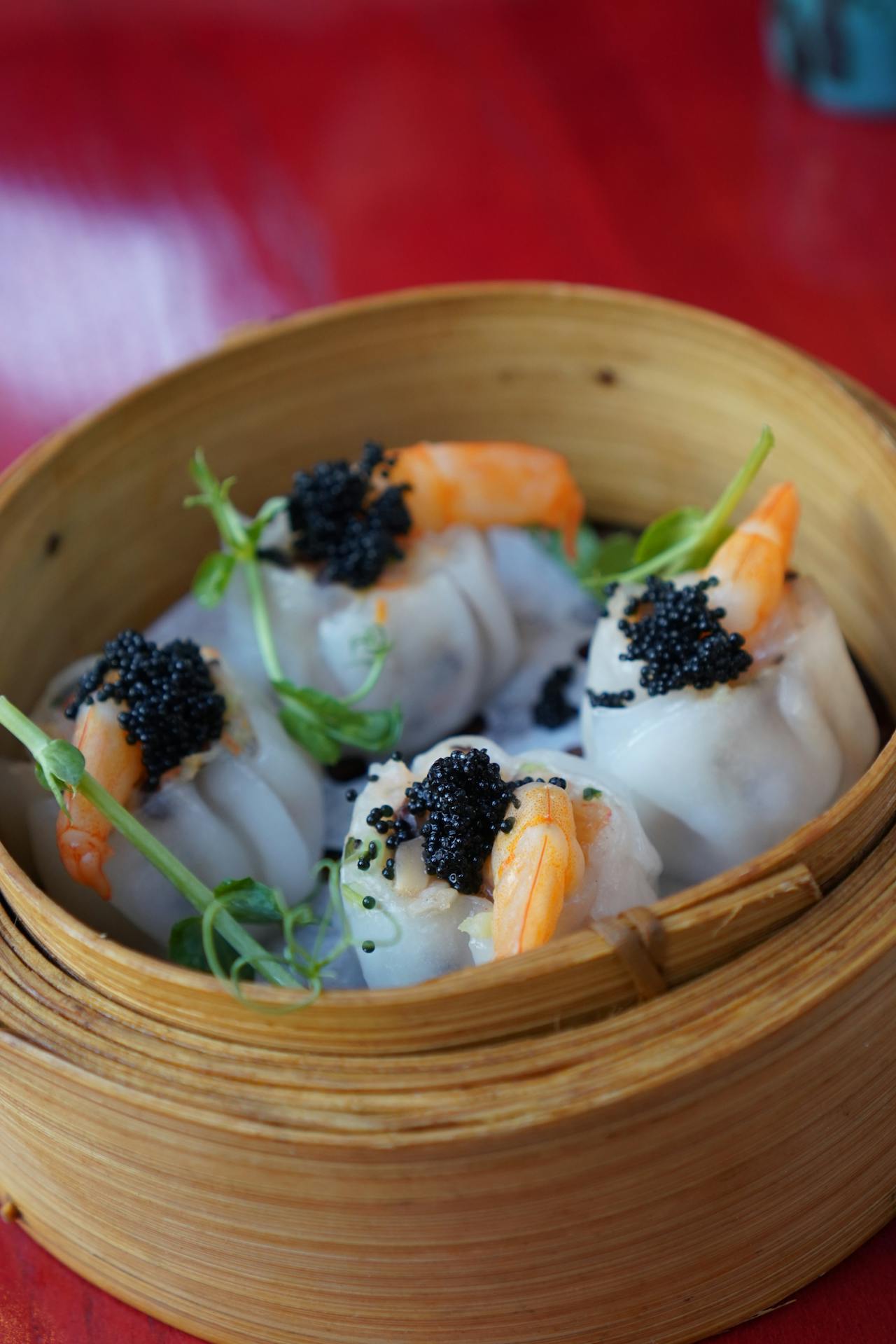 rice dumplings with shrimp and caviar in bamboo bowl