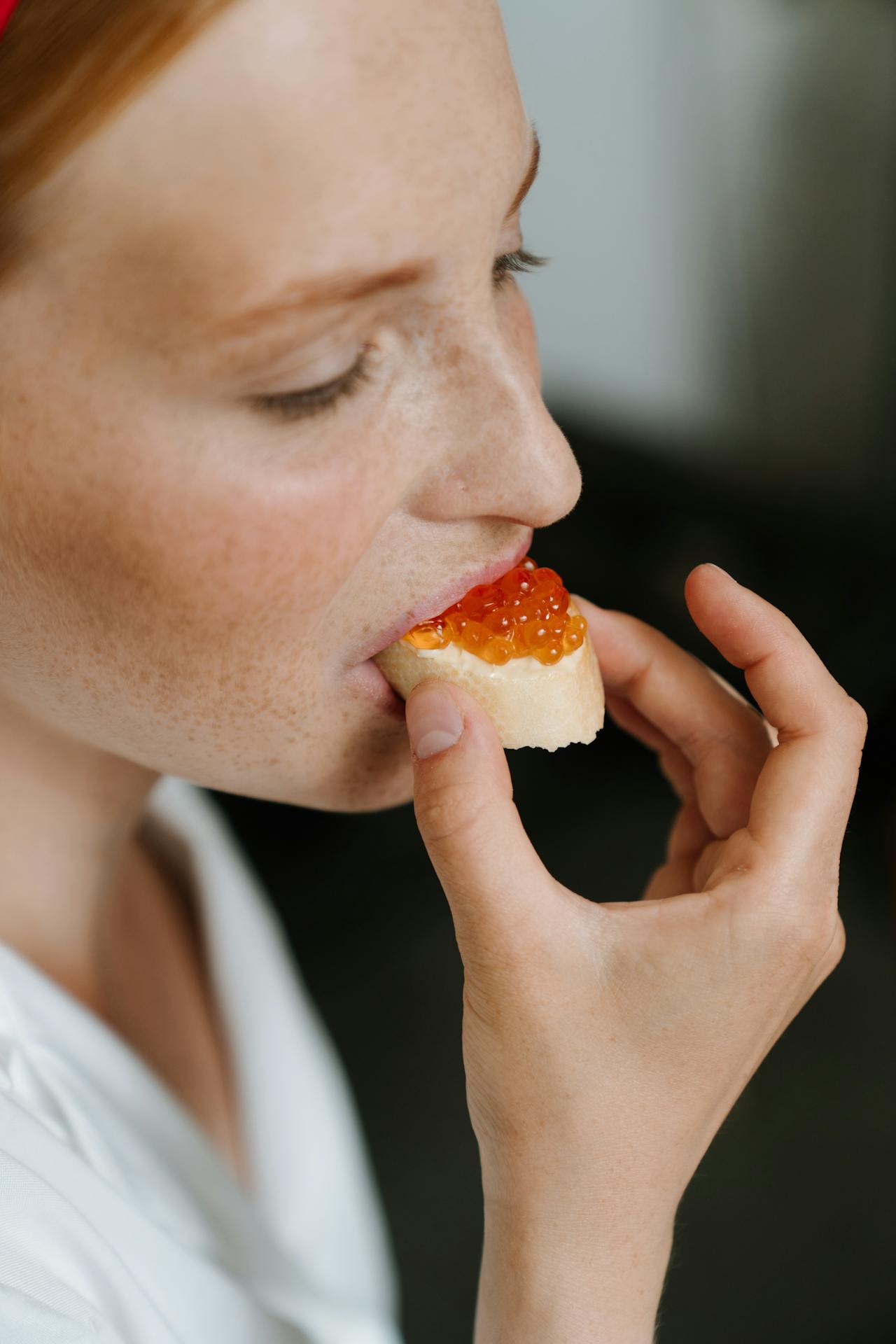 woman eating fresh fish roe on bread