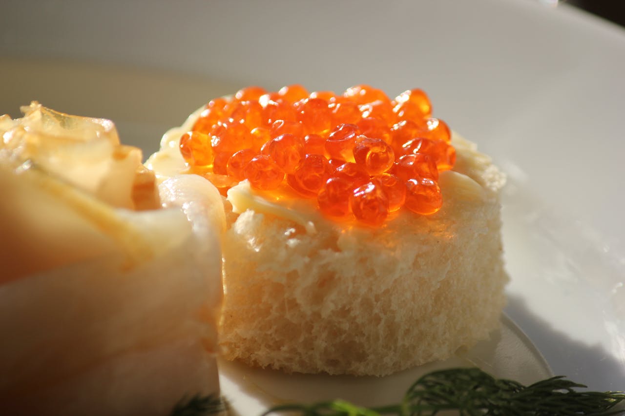 closeup of cake topped with red-orange caviar