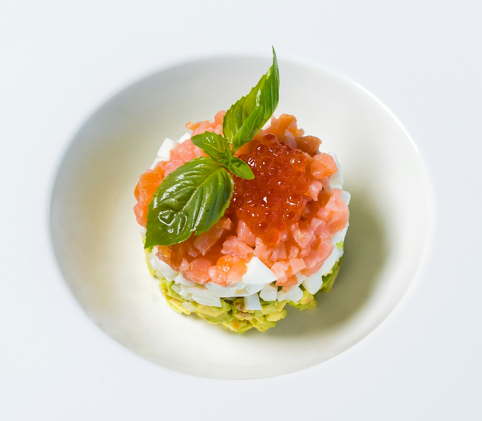 red caviar appetizer on white plate