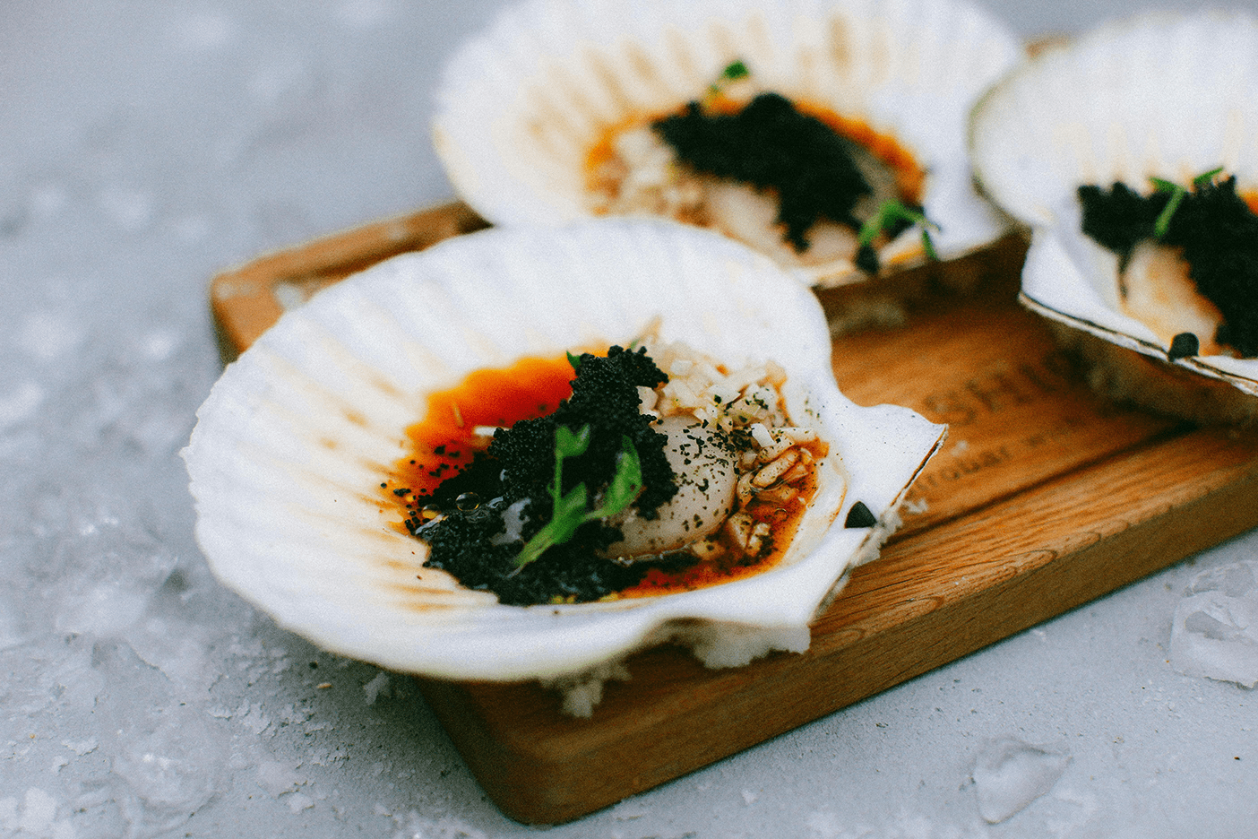 Scallop shells topped with seafood and American caviar