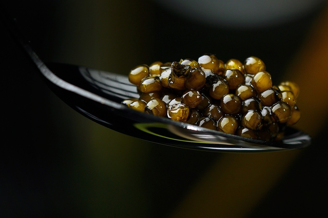 closeup of black caviar on spoon