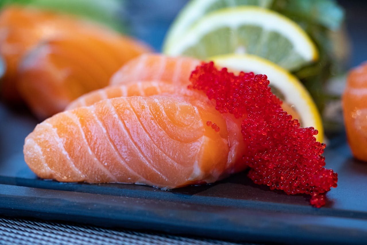 closeup of salmon with red caviar and lemon slices