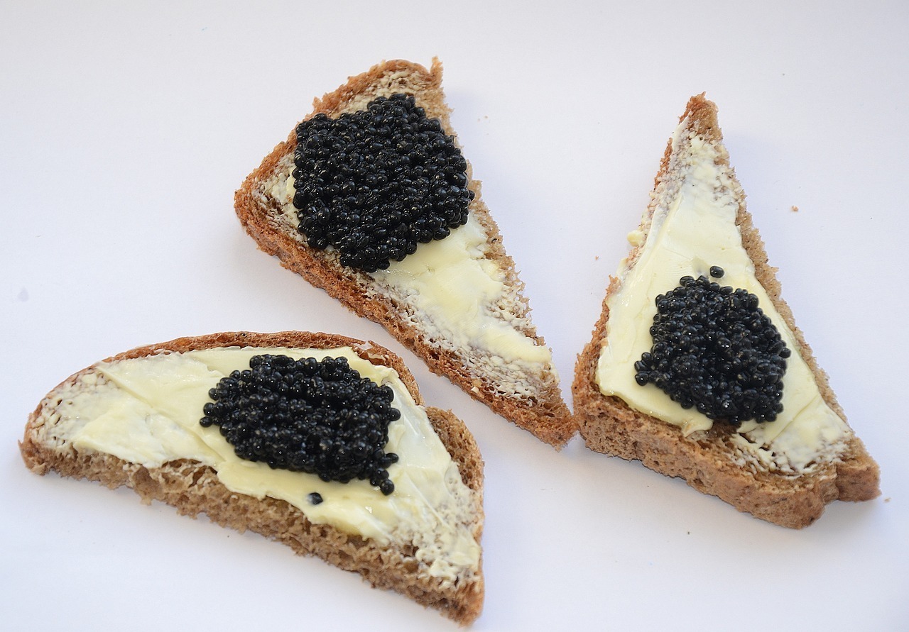 three toast points with butter and caviar