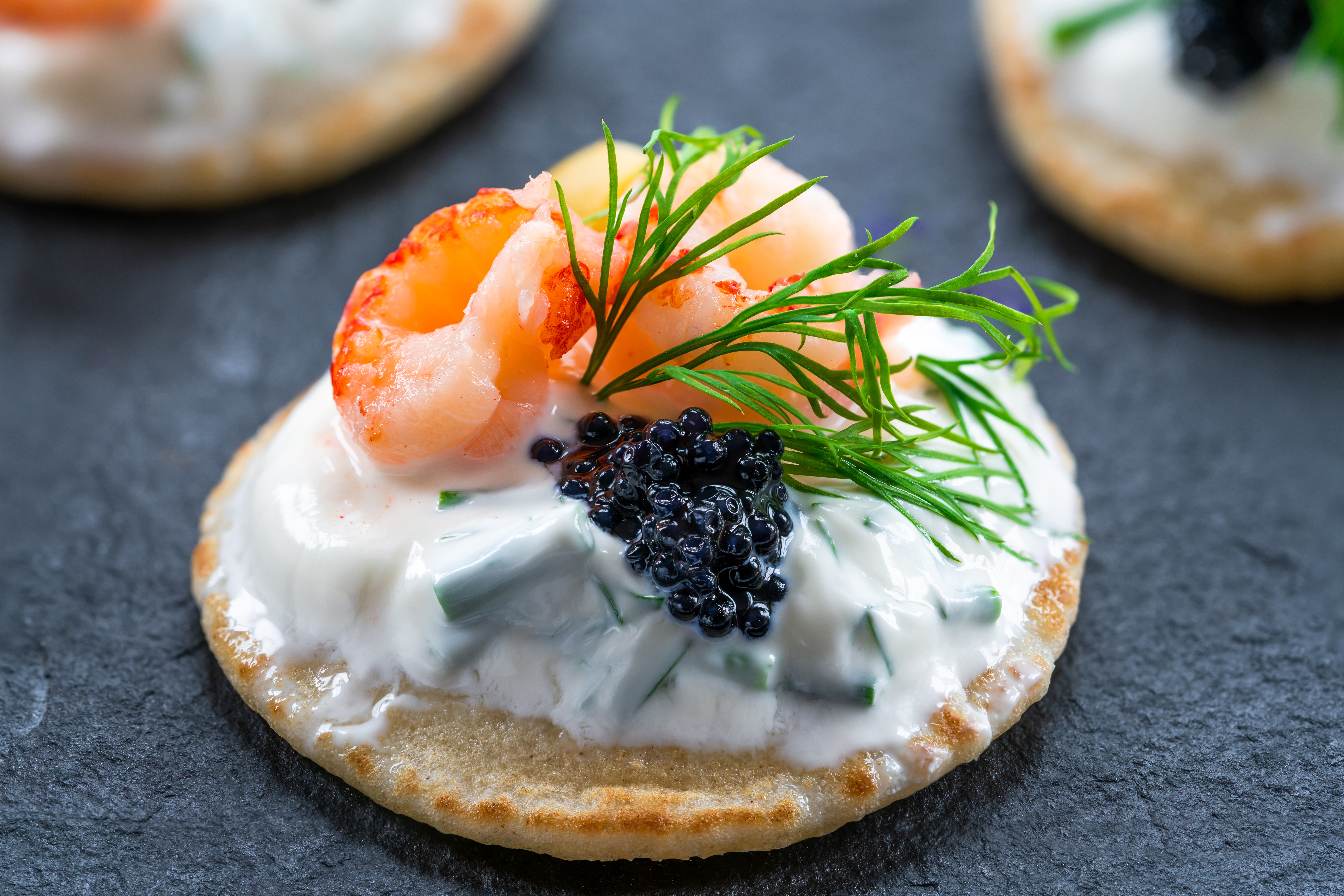 Caviar and sour cream on blinis