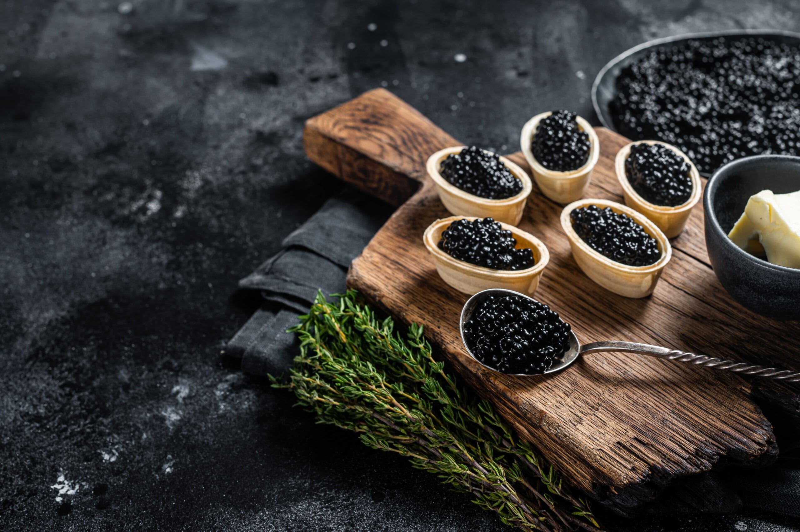 Tartlets with Sturgeon caviar on wooden board