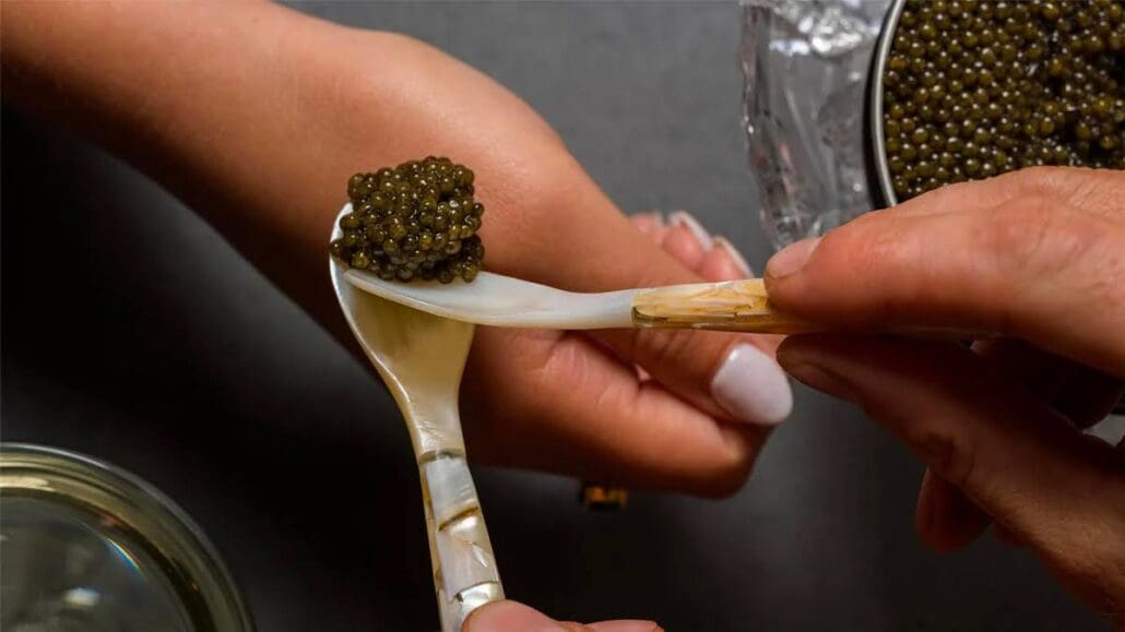 Placing caviar on the back of a person’s hand