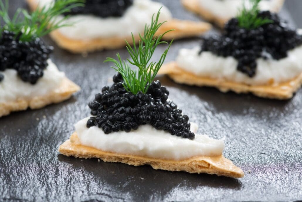 Caviar served on crackers with crème fraîche