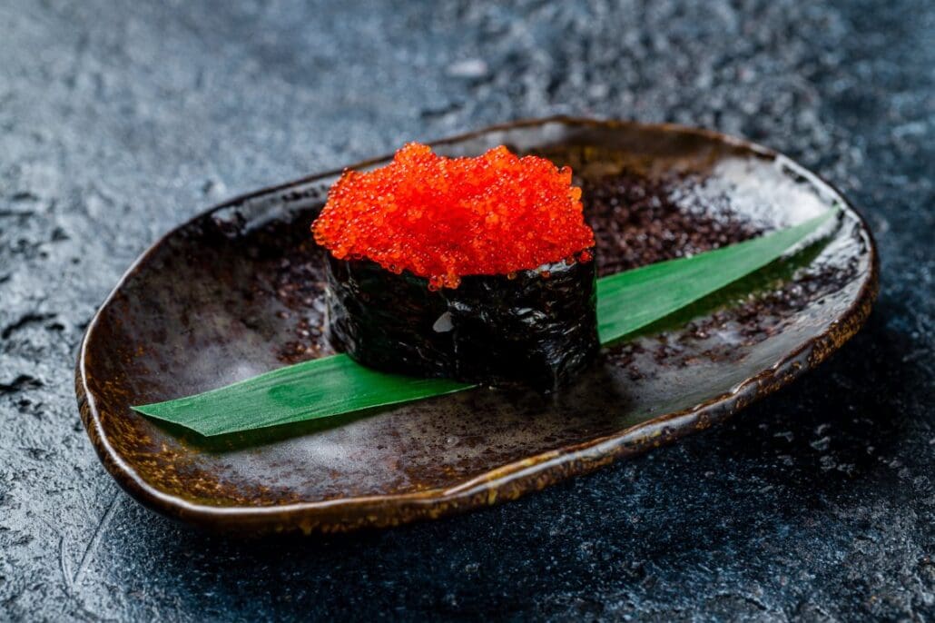 A sushi roll topped with masago